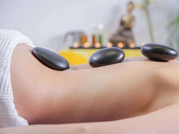Warm massage stones resting on the back